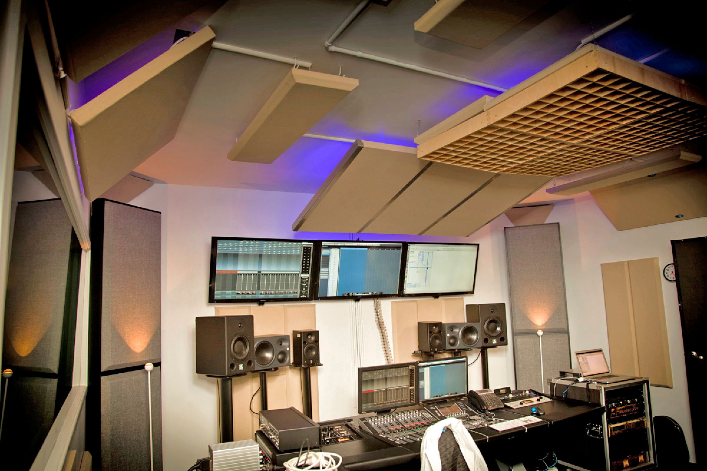 Recording studio with beige acoustic panels on wall and ceiling