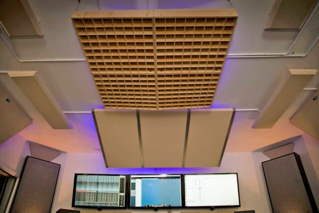 recording studio with beige acoustic panels on ceiling and a acoustic diffuser