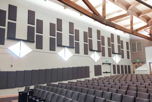 Grey acoustic panels on wall of auditorium