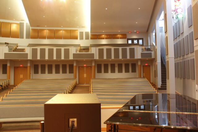 View from church stage with grey acoustic panels on back walls
