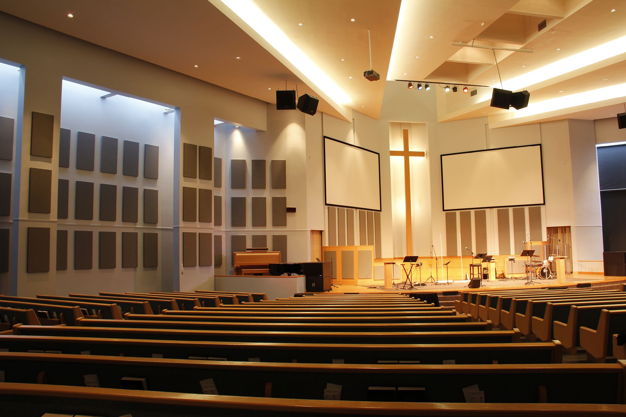 Empty church with grey acoustic panels on walls