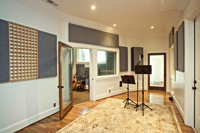 Recording studio with white walls and grey acoustic panels installed