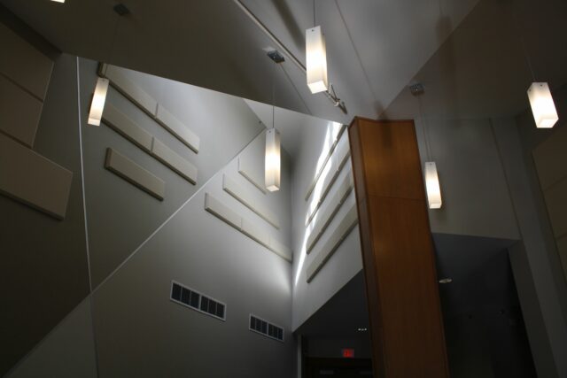 Conference centre with high ceilings and white acoustic panels on walls