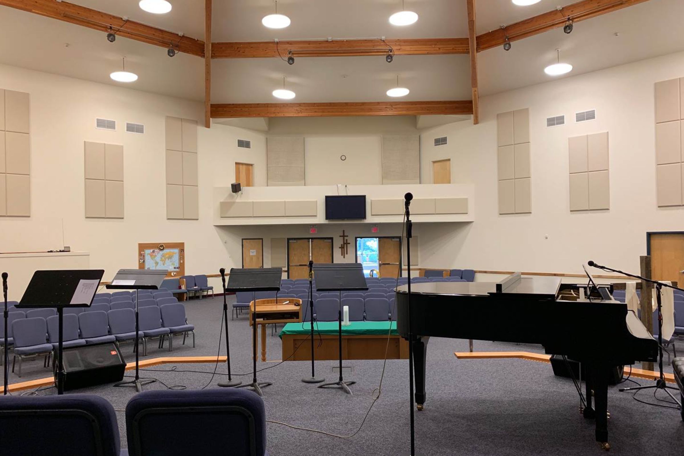 Nazarene church with white acoustic panels hanging on back wall