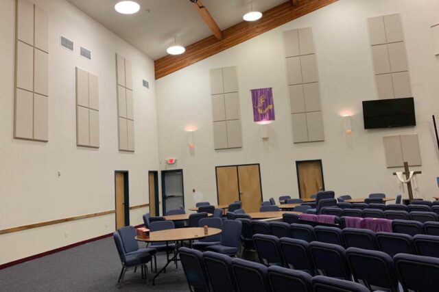 Empty Nazarene church with white acoustic panels installed on walls