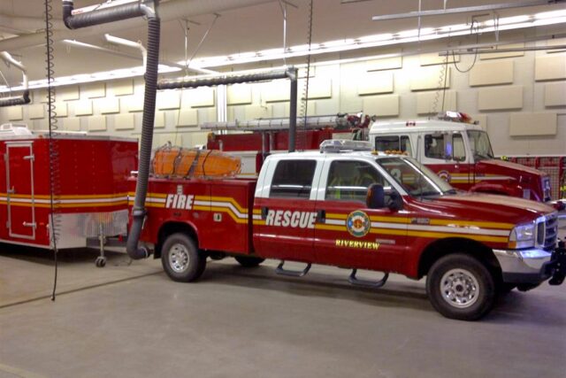 Fire department parking garage with white acoustic panels installed on walls