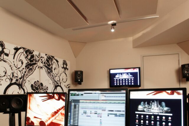 Studio mixing centre with custom printed acoustic panels on walls and white acoustic panels and corner panels on ceiling