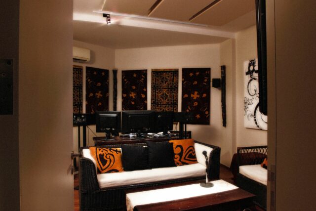 Recording studio mixing station with custom printed acoustic panels on walls and white panels on ceiling