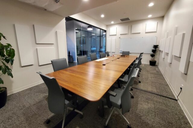 Empty business boardroom with white acoustic panels installed on all walls