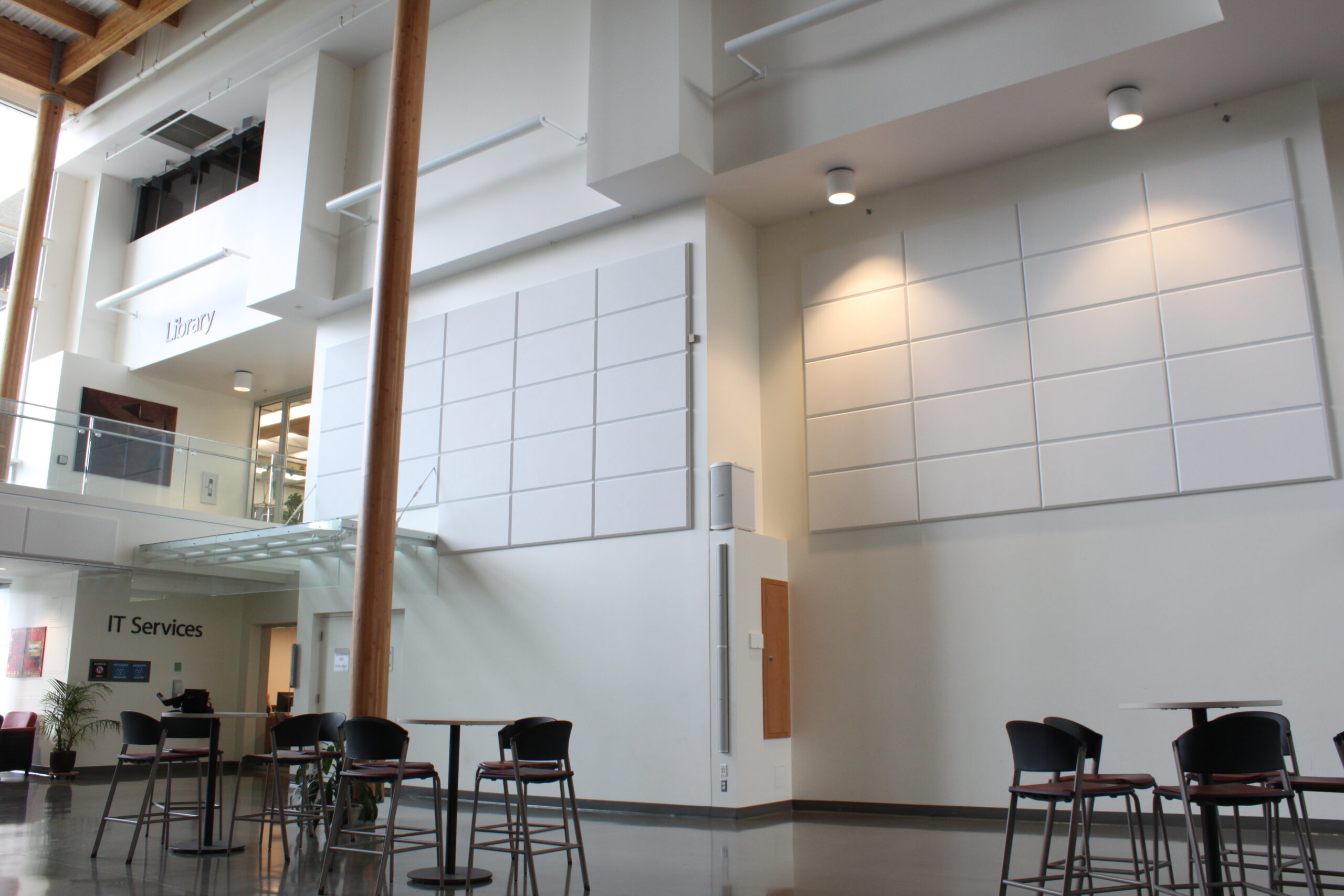 Inside college building with white walls and white acoustic wall panels