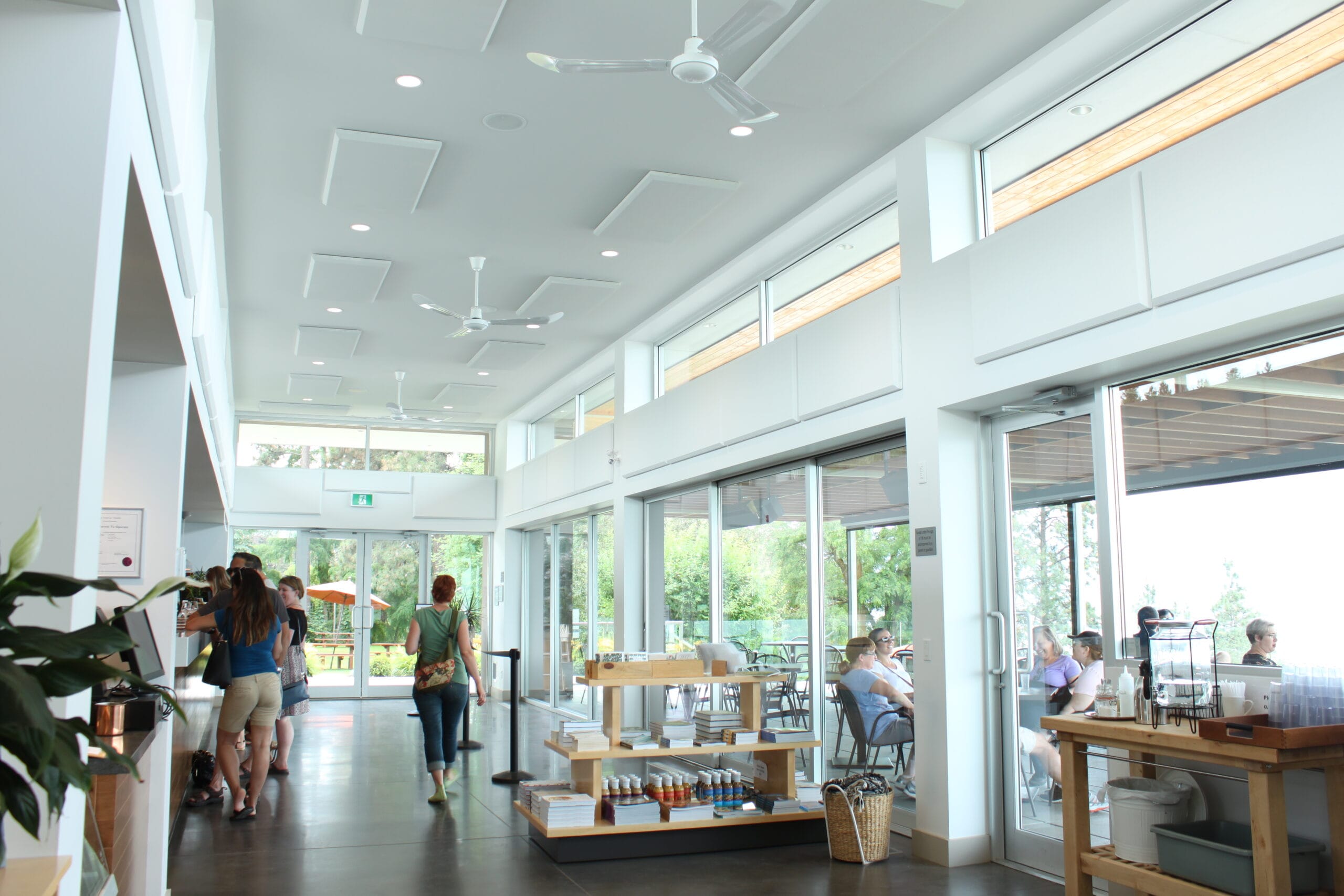 People in large white room with white acoustic panels on ceiling.