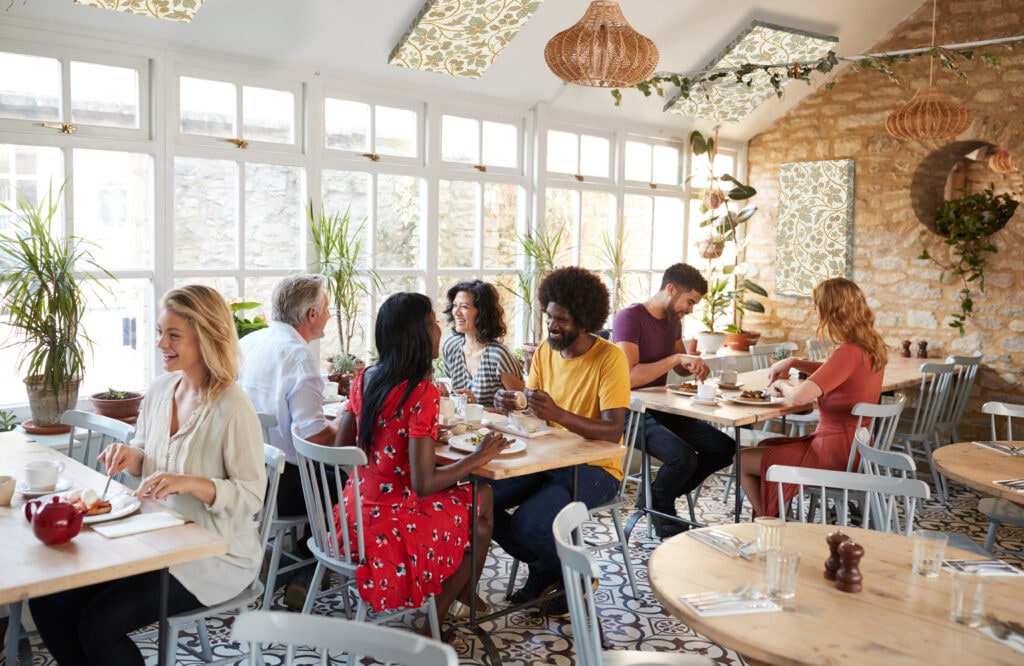 Customers Eating At A Busy Restaurant In The Day Time